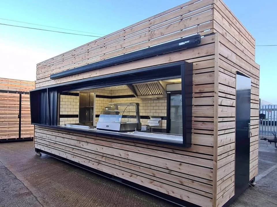 Timber-clad container food kiosk with glazed servery window, built by D & B Solutions